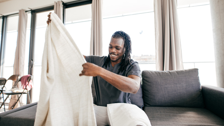 man folding sheet