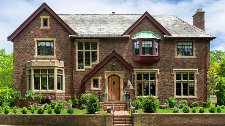 Tudor-style home with short, well-maintained hedges in front