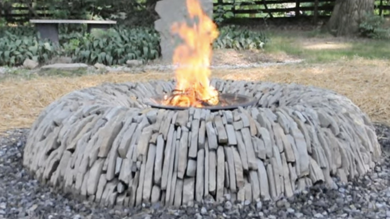 An impressive stone fire pit added to a backyard