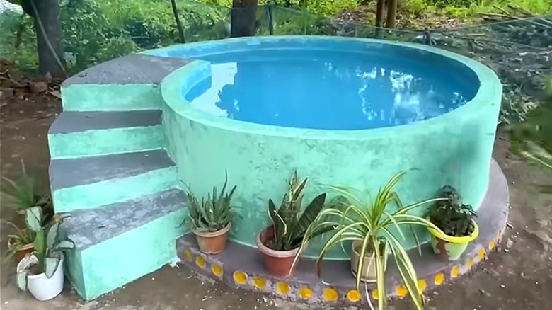 The finished plunge pool made with bottles, bricks, and concrete
