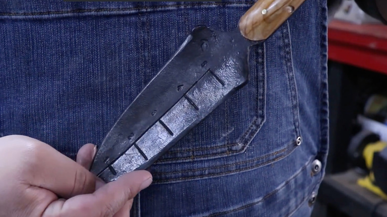 A functional garden trowel made from an old lawnmower blade