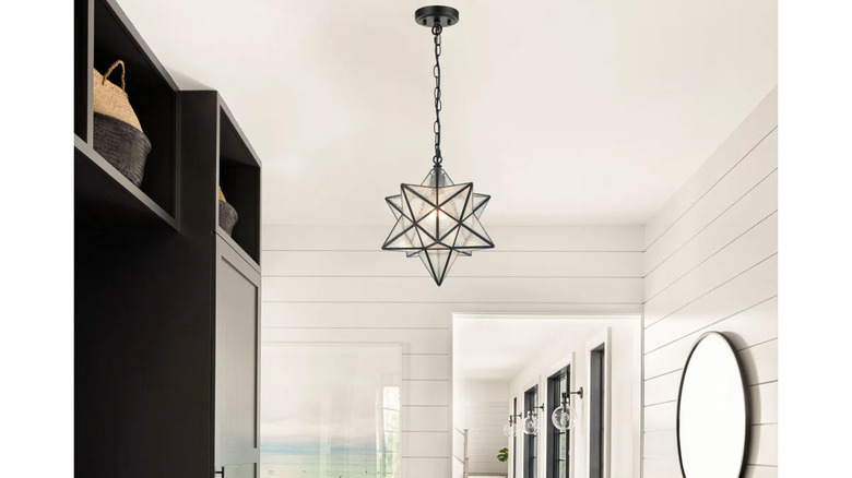 Ebern Design's Moravian Star Pendant Light 14-inch Seeded Glass Shade hangs in a room.