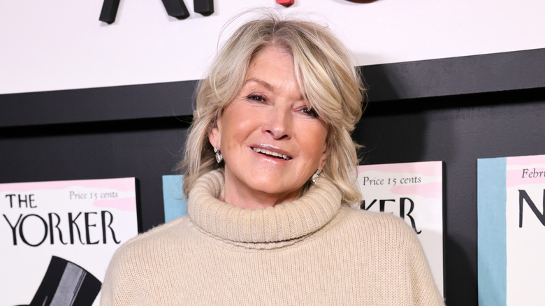 Martha Stewart in beige turtleneck sweater smiling at event.