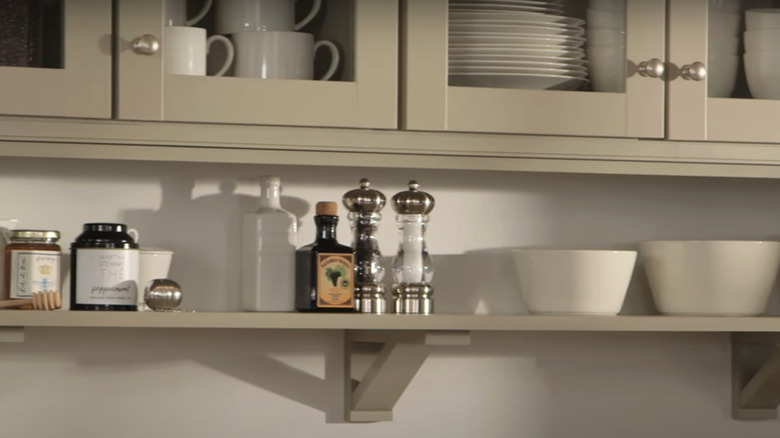A close up on kitchen cabinets and a shelf.