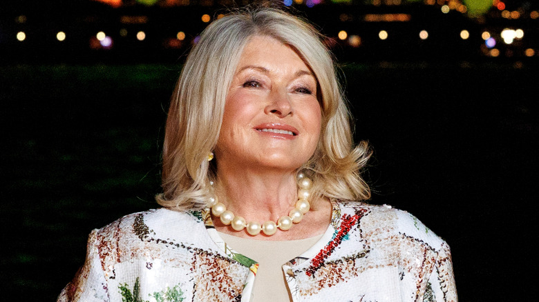 Martha Stewart smiling against black background