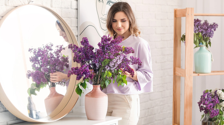 Woman arranging lilacs