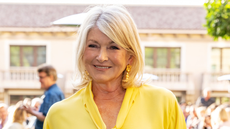 Martha Stewart smiling in a yellow shirt.