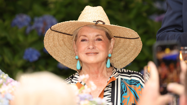 Martha Stewart smiling and wearing large straw hat