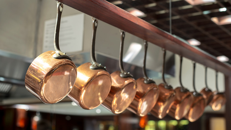 copper pots hanging from ceiling