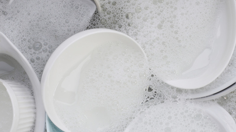 Dishes soaking in soapy water