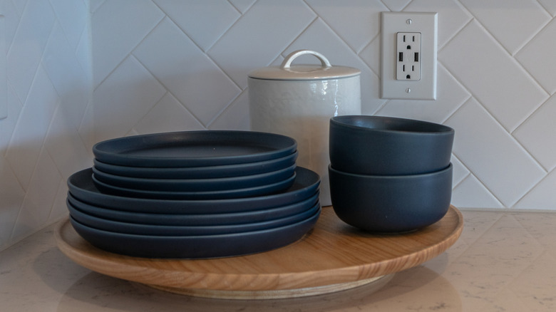 Wooden lazy Susan with a variety of dishes stacked on top