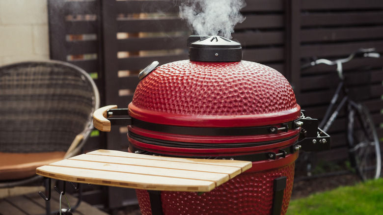 An up close view of a red ceramic grill.