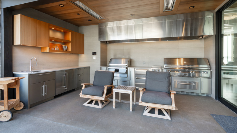 A fully equipped outdoor kitchen with stainless steel cabinets.