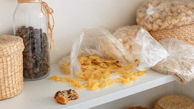 An interior view of a messy kitchen cabinet