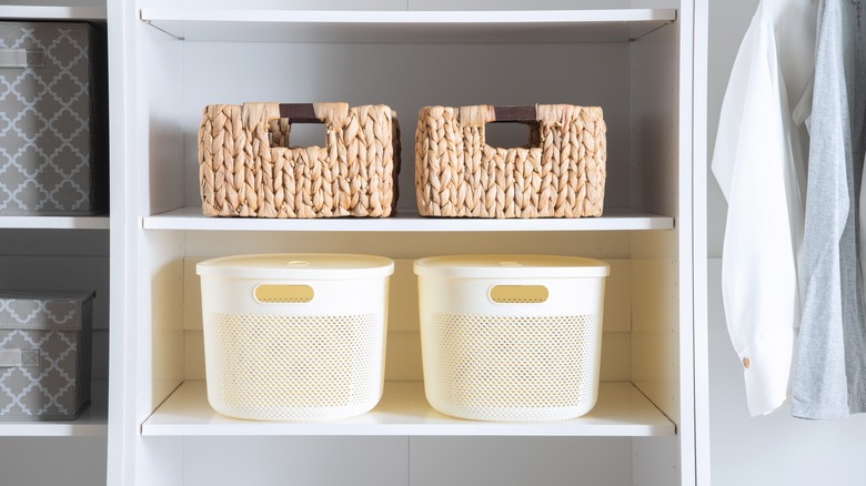 Unlabeled bins on the shelves of a closet
