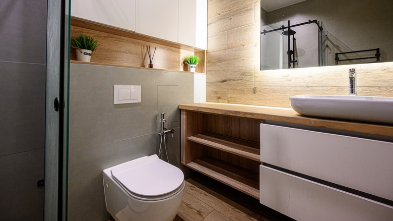 Sleek and modern bathroom with no visible hardware on cabinets