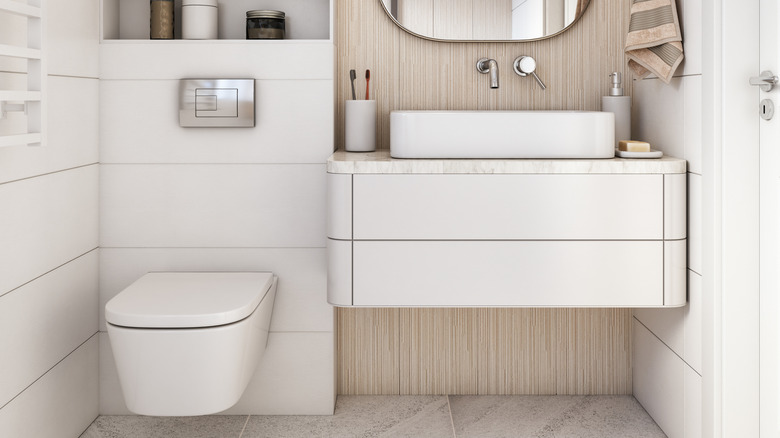 Very modern bathroom with over the toilet storage
