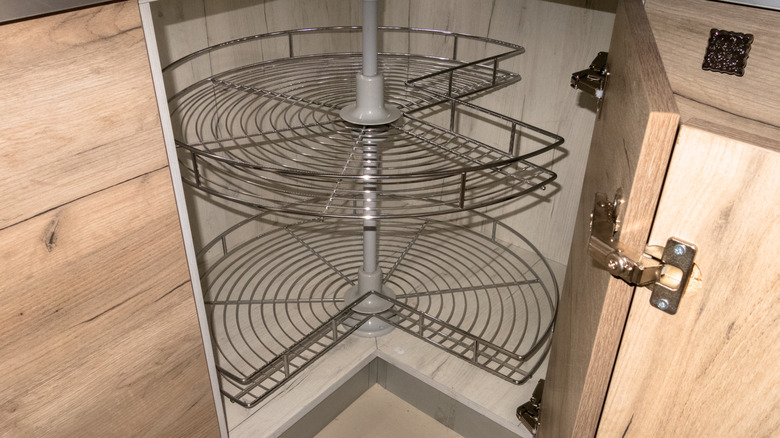 A lazy Susan made of wire shelves in a corner cabinet