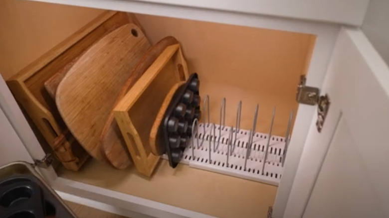 cutting boards and baking pans in an organizer