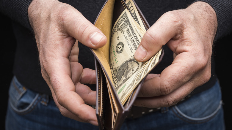 Dollar bill peeking out of wallet