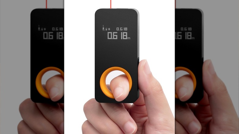 person holding HOTO laser measuring tool