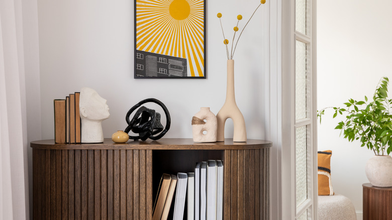 Larger decor items on wood shelf