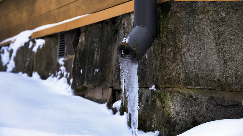 icy drain pipe outside of home