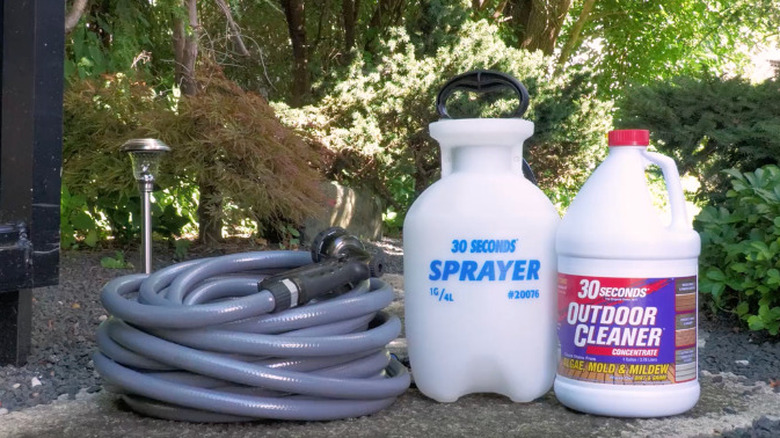 30 Seconds Outdoor Cleaner next to a spray bottle and hose