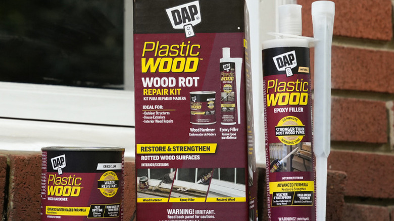DAP's Plastic Wood Rot Repair Kit displayed in front of a window