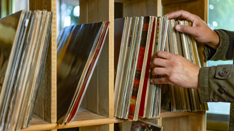 Person looking at vinyl records on a shelf