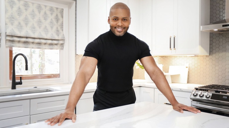 Michel Smith Boyd posing in a white kitchen