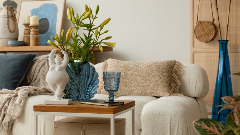 Living room with neutral tone sofa with blue accent decor