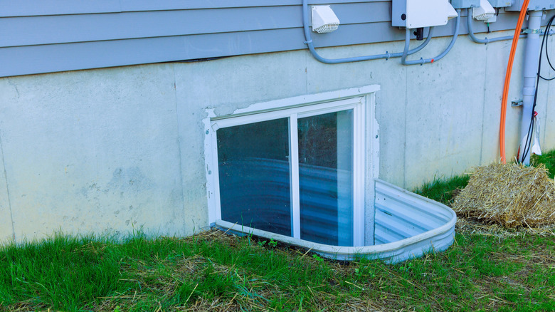 View of a basement egress window from the outside of the house.