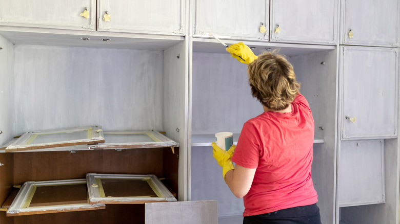 woman painting cabinets
