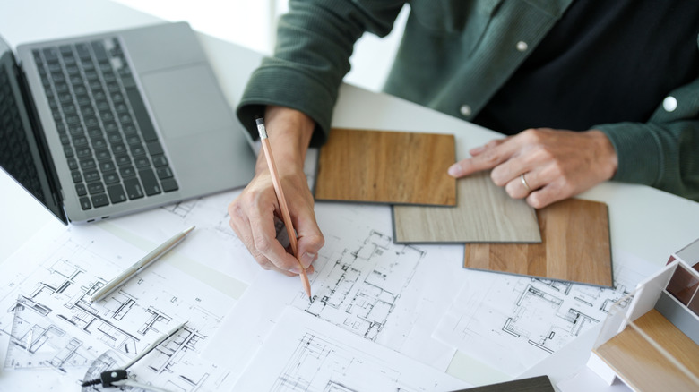 person drawing building plans