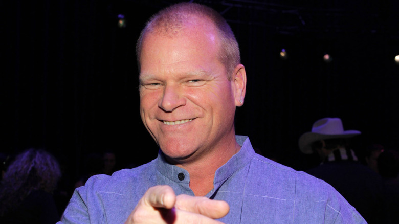 HGTV's Mike Holmes smiling and pointing at an event