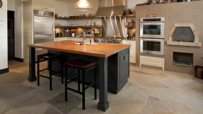 Modern kitchen with a natural stone floor.