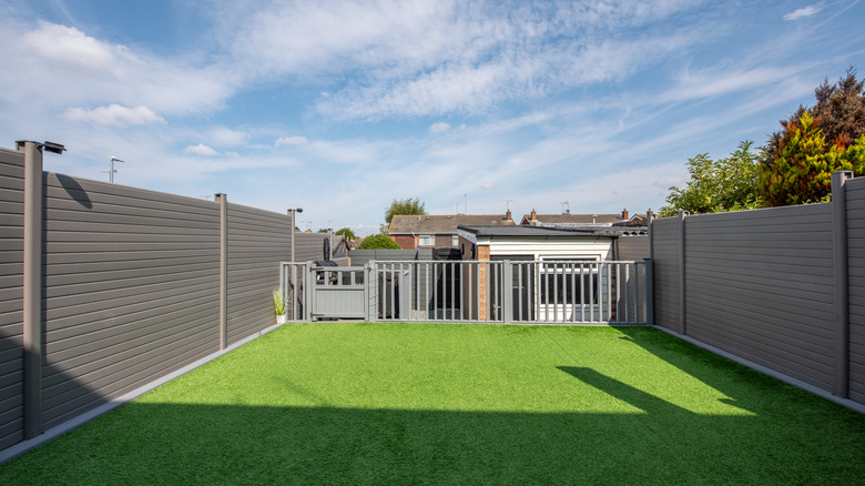 Gray composite fence around a backyard