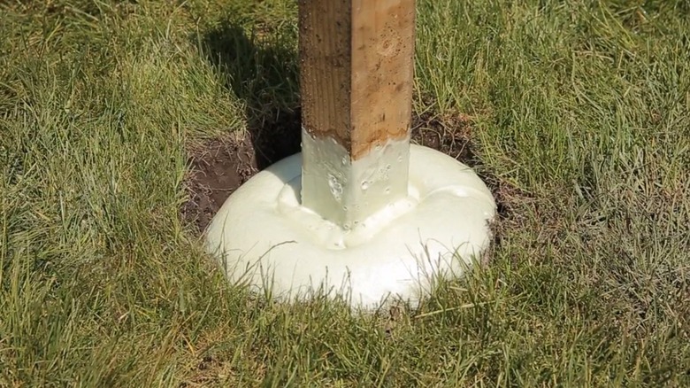 Fence post held in place with expanding foam