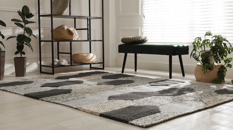 A textured area rug on the floor of a modern living room.