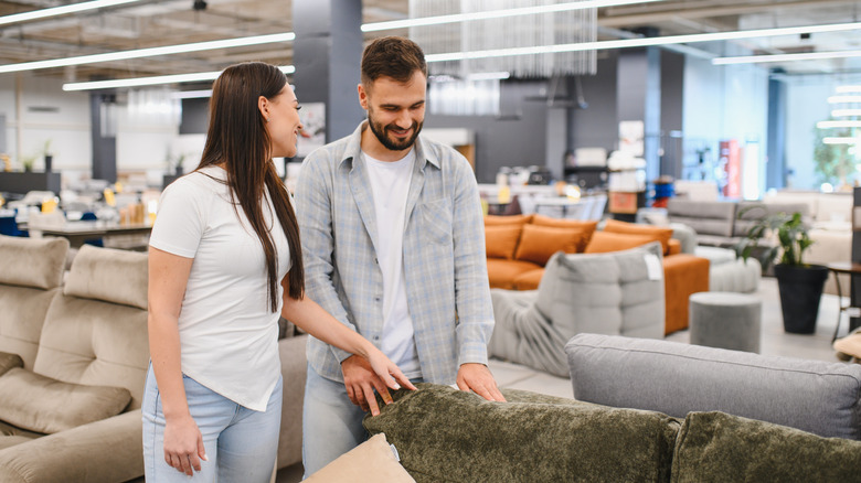 Young couple shopping for furniture in a large department store