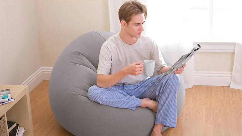 Man sitting on bean bag-style inflatable chair