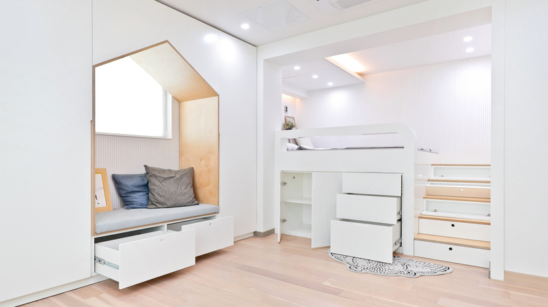 Hidden storage drawers and cabinets in a white bedroom