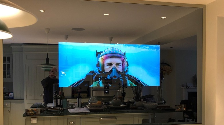 A large mirror TV playing in the kitchen