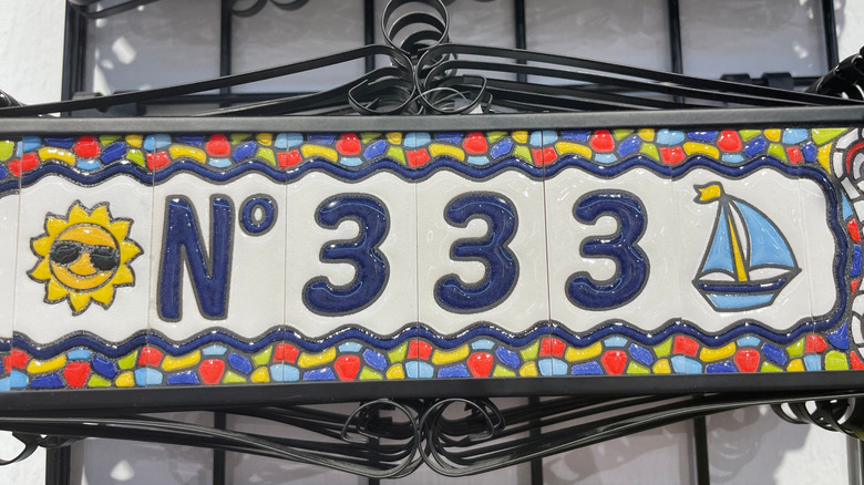 fun house number with multi-color detailing of a sun and sailboat