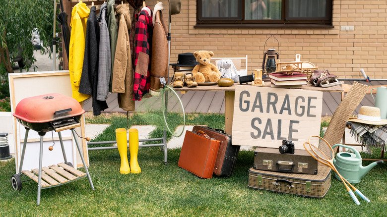 Items for sale on a table at a garage sale.