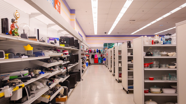 Inside of a secondhand shop with several aisles.