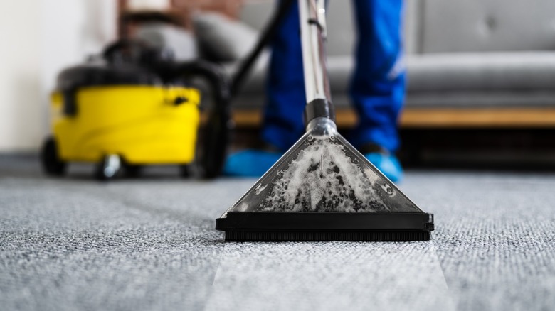 Person using carpet cleaner 