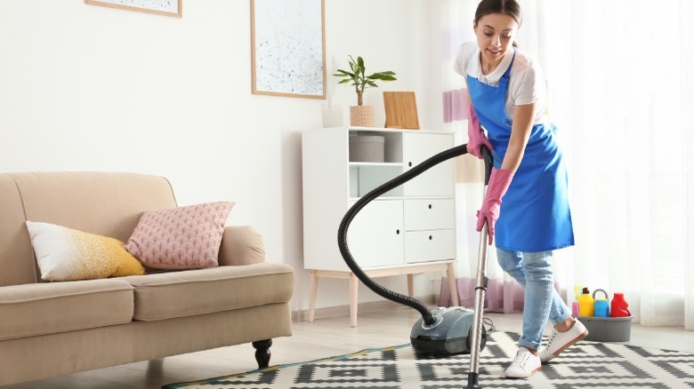 Woman cleaning carpet 