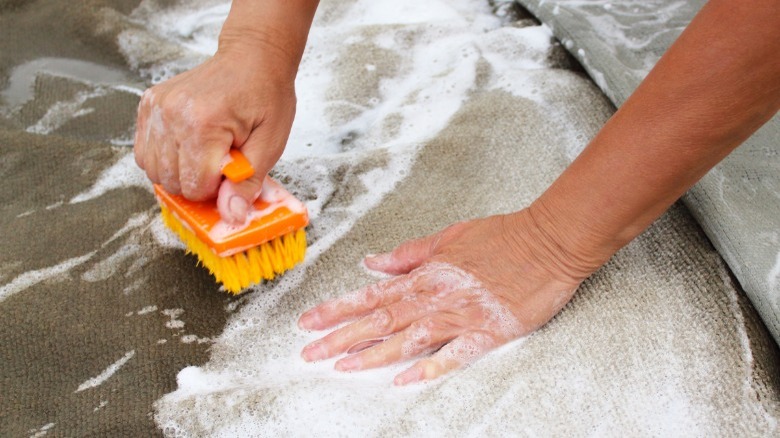 Man shampooing carpet by hand 